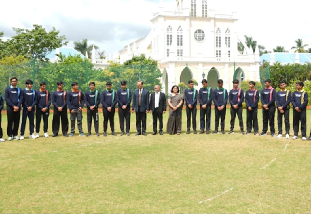 Students practicing track athletics on the outdoor sports field at Sarala Birla Academy